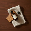 What ships: the bottle, its cap and a linen cloth