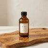 The care oil standing on an olive wood board