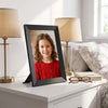 The frame standing in portrait on a bedside table