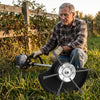 Man kneeling by an overgrown fence line next to his gas trimmer fitted with the Thornwell steel wire head