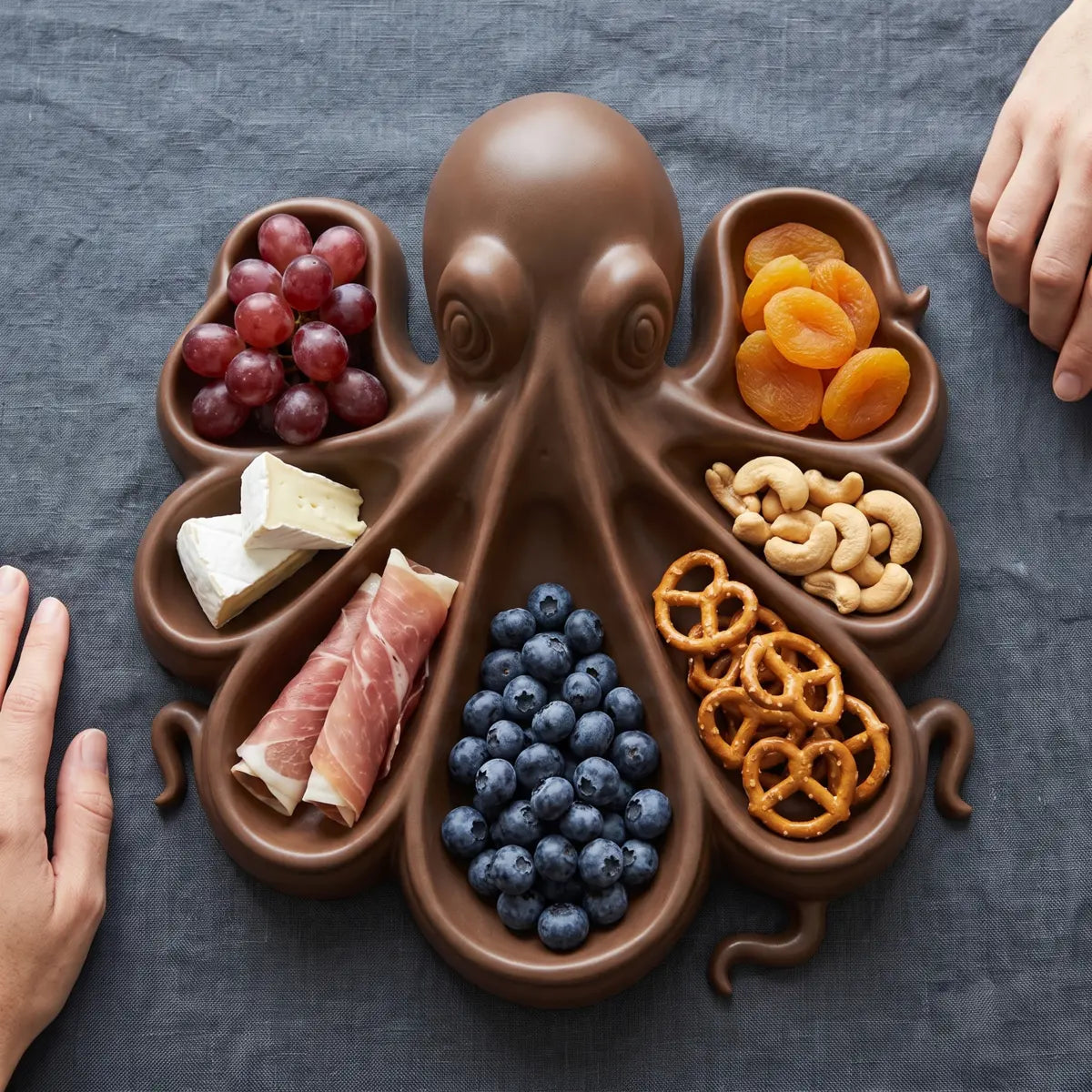 Octopus serving platter seen from above, a different food in each of its seven compartments