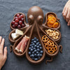Octopus serving platter seen from above, a different food in each of its seven compartments
