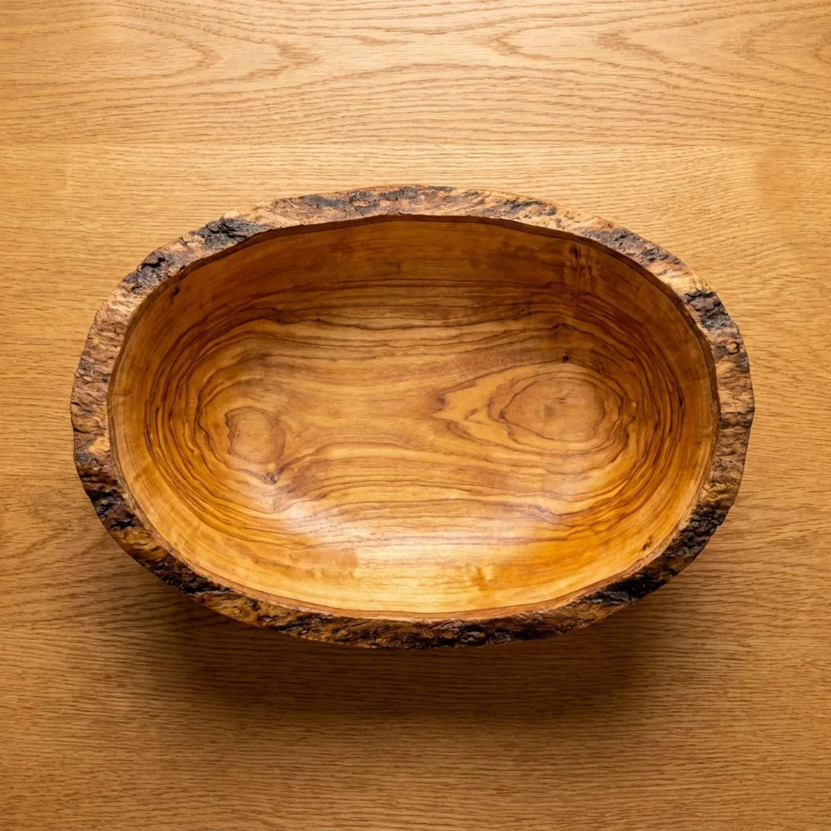 The empty olive wood bowl seen from above, full swirl of the grain