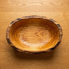 The empty olive wood bowl seen from above, full swirl of the grain
