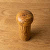 The Alba Olive Wood Pepper Mill seen from above, the full grain readable