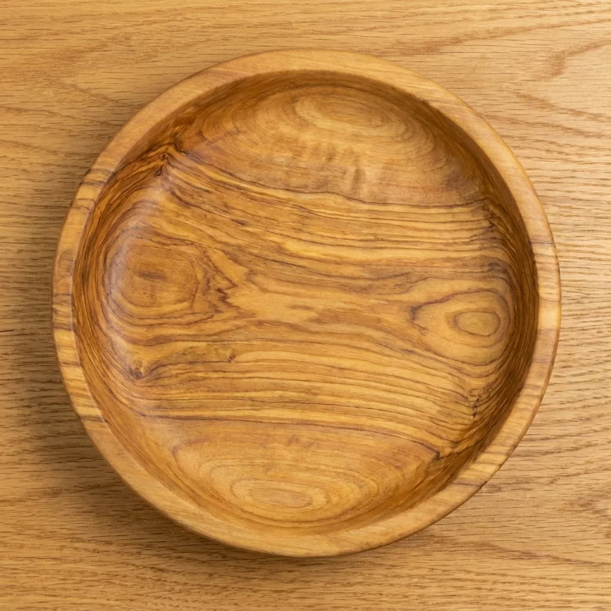 The Alba Olive Wood Bread Bowl seen from above, the full grain readable