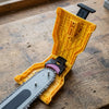 Ridgeford sharpener opened, pink stone resting on the chain at the nose of the bar