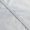 Close-up of the waterproof outer face with water beading on a welded seam
