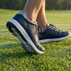 Mid-stride on a wet green, the sole gripping