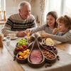 Grandfather and two grandchildren reaching for snacks in the octopus platter at the kitchen table