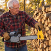 Man by his woodpile holding a chainsaw with the Ridgeford sharpener on the bar tip