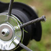 Close-up of the twisted steel cables and crimped tip on the steel disc