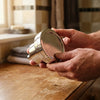 The filtered shower head held in two hands, whole product visible