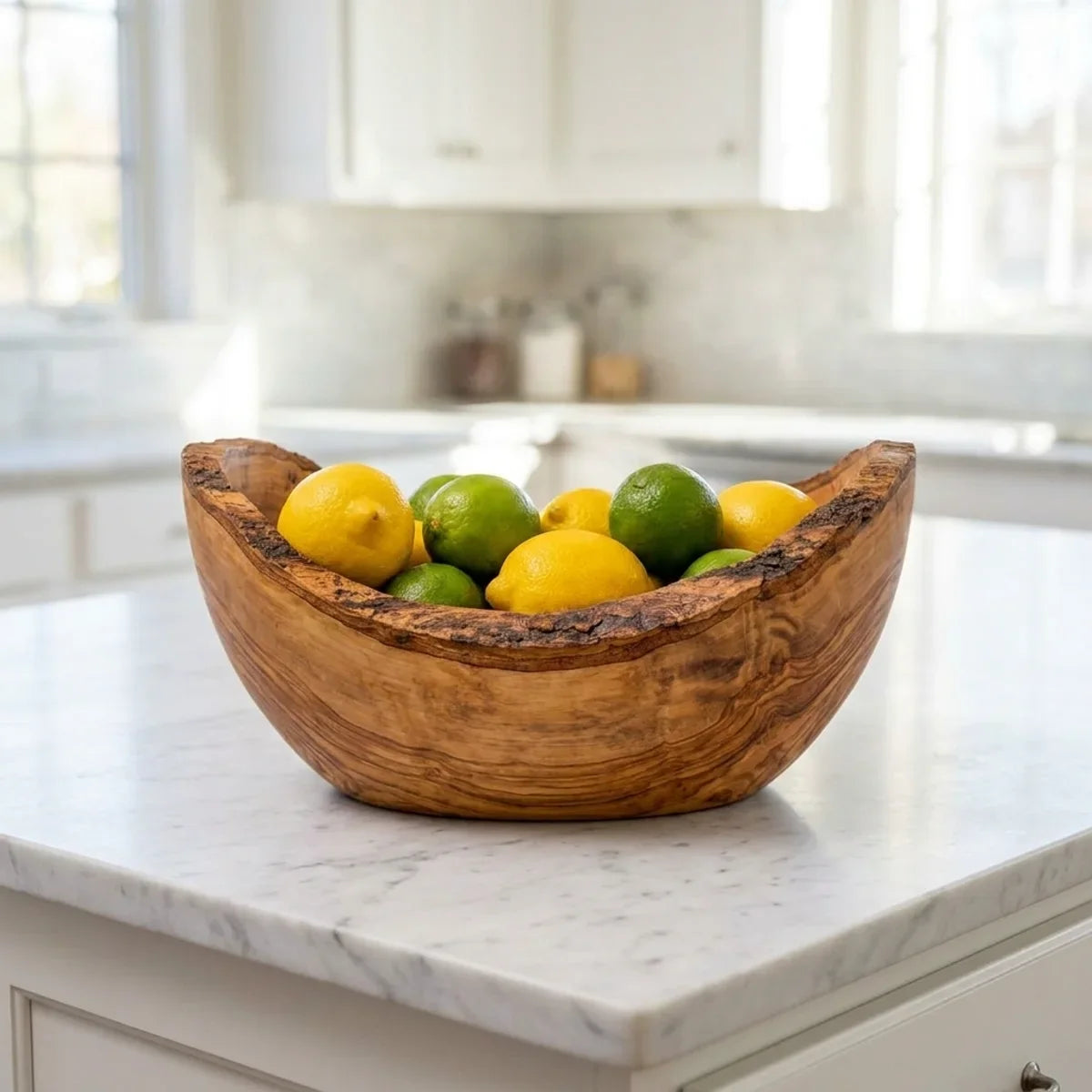 The bowl on a kitchen island filled with lemons and limes
