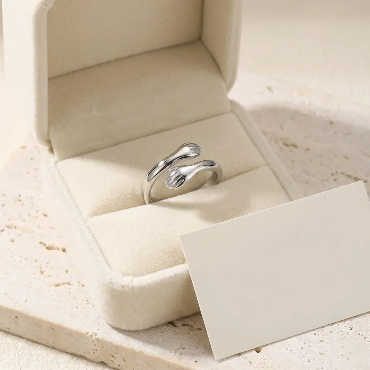 The Hug Ring in its open gift box with a blank message card