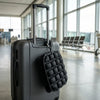 Clips to a carry-on handle