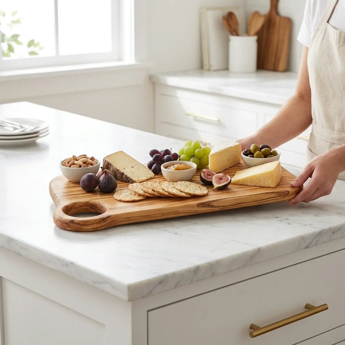 The Alba Olive Wood Board with Grip Hole in use on a kitchen island