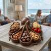 Octopus platter filled with cookies, chocolates and nuts on a coffee table in a seaside living room