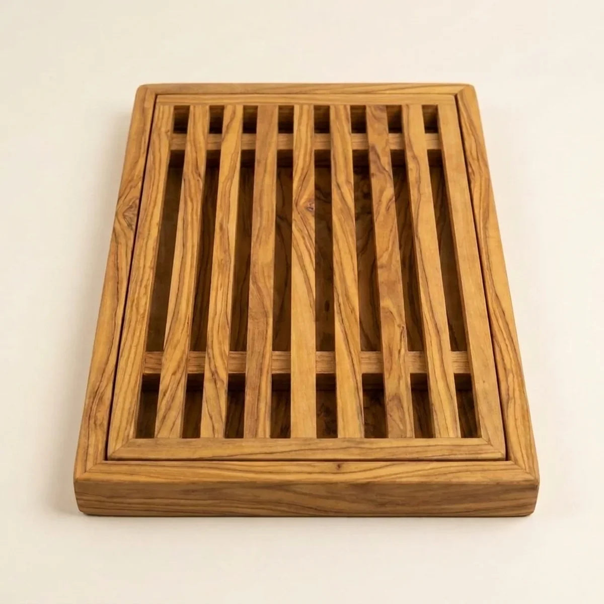 The Alba Olive Wood Bread Board with Crumb Tray alone on a plain background